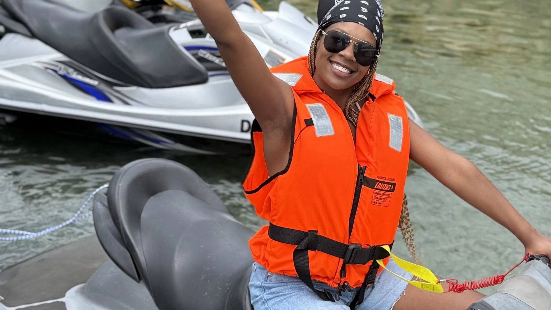 Smiling rider in life jacket beside a jet ski in Cape Town